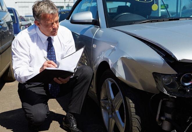 person signing paper for car insurance coverage